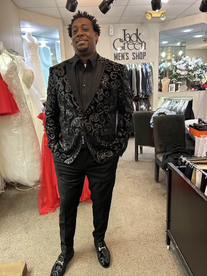 Client smiling in black sequin swirl blazer