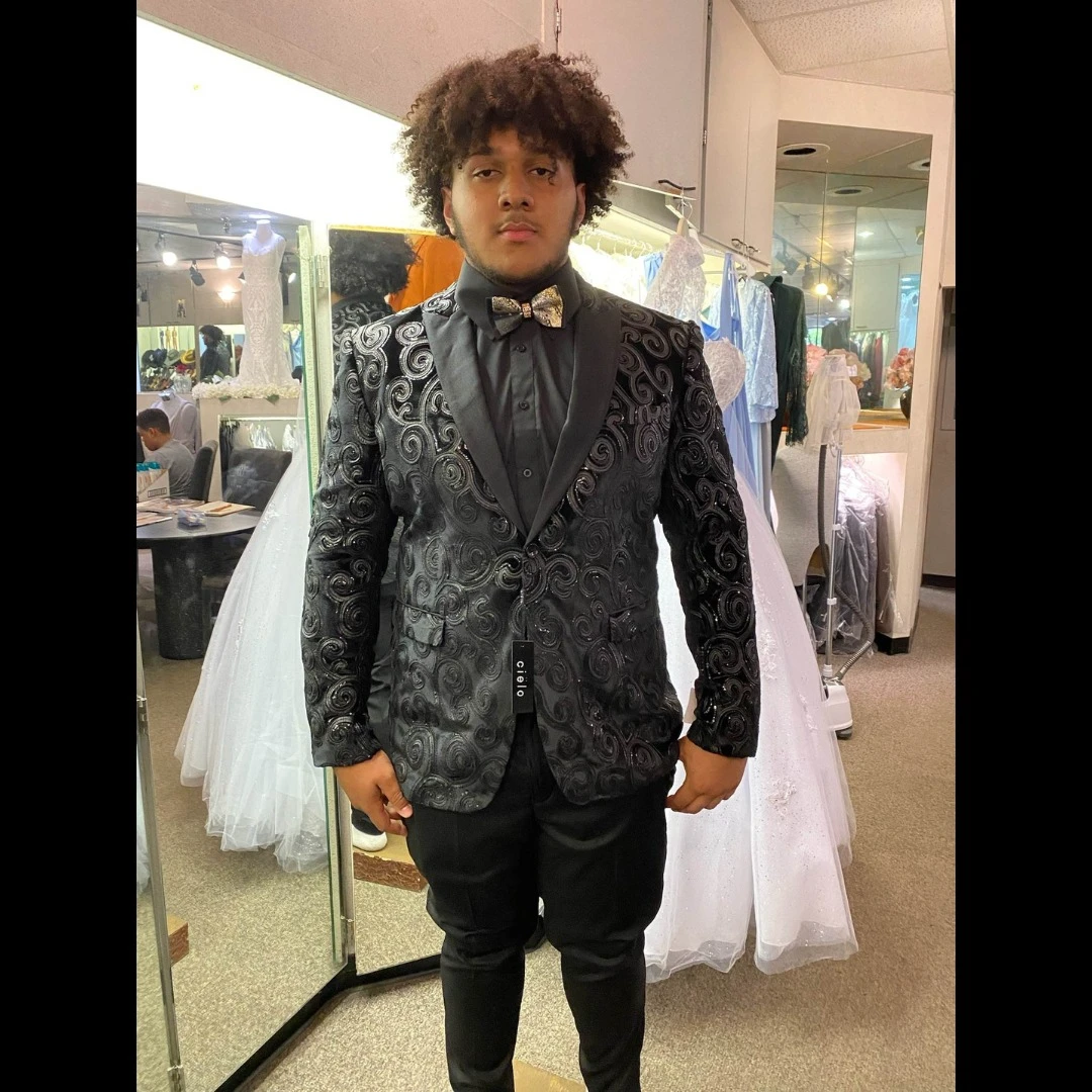 Adult client in black swirl pattern blazer with matching loafers