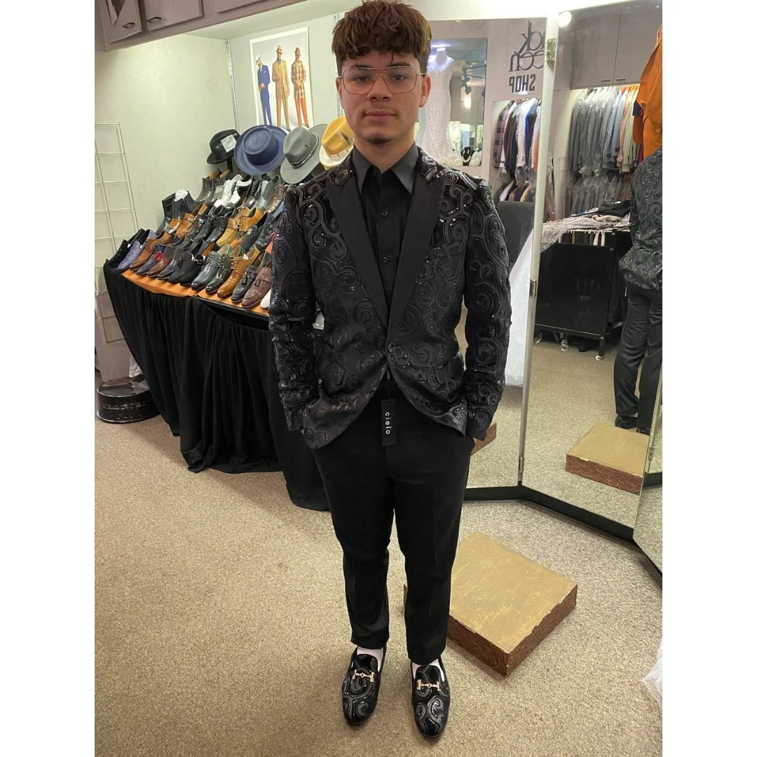 Client in black swirl pattern blazer with matching patterned loafers