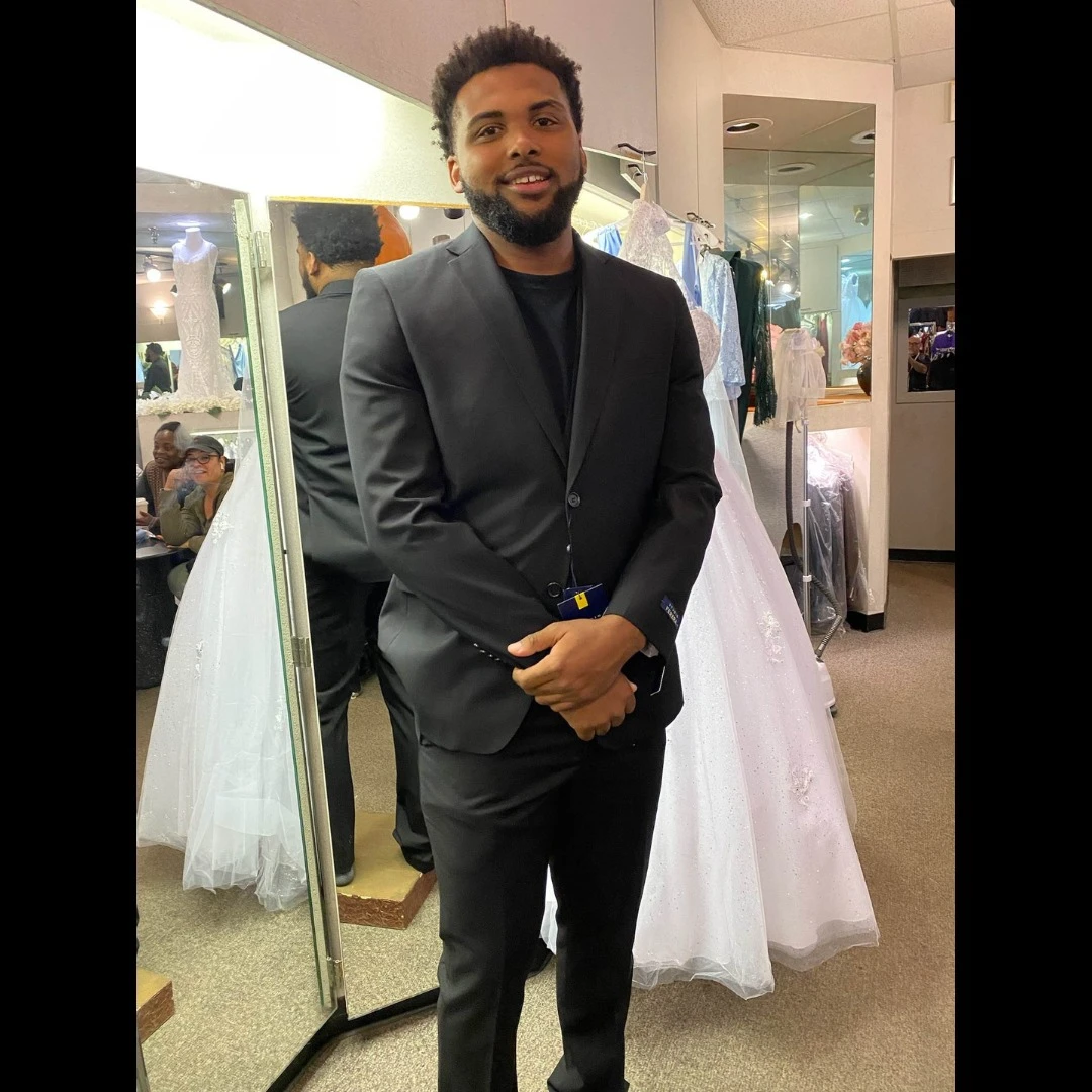 Client in charcoal suit with black t-shirt