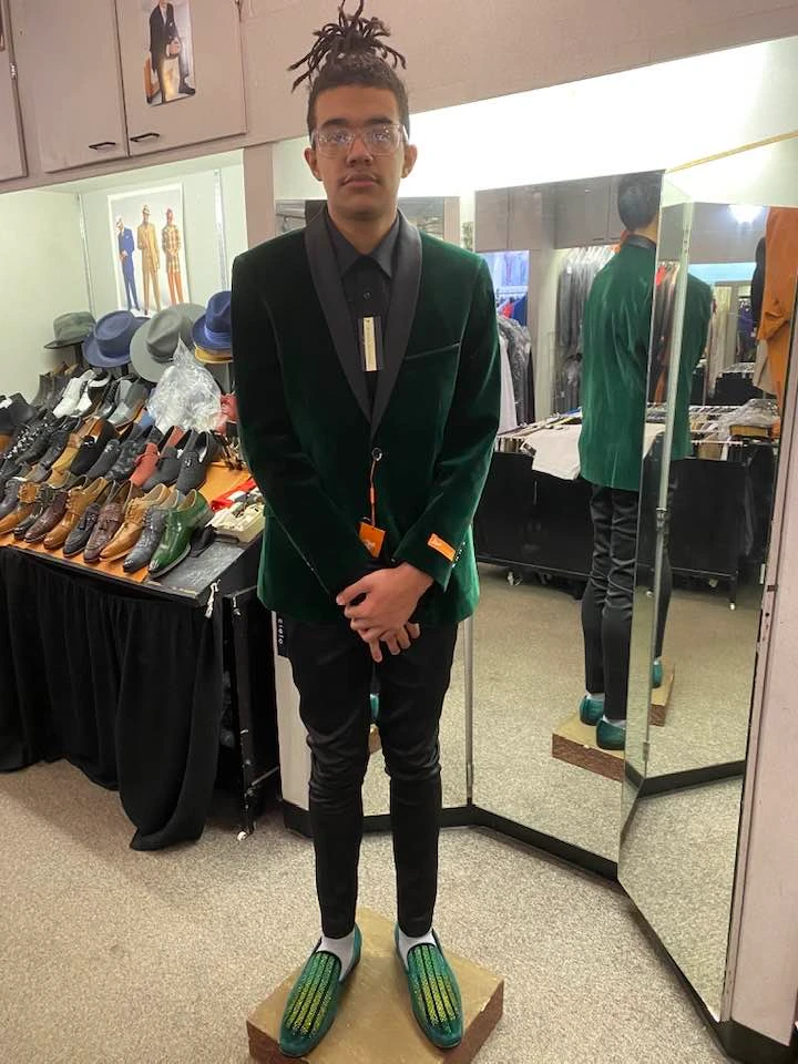 Client in emerald green velvet blazer with matching green loafers