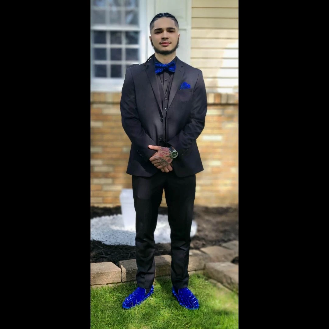 Client in navy three-piece suit with blue crystal loafers and matching bow tie