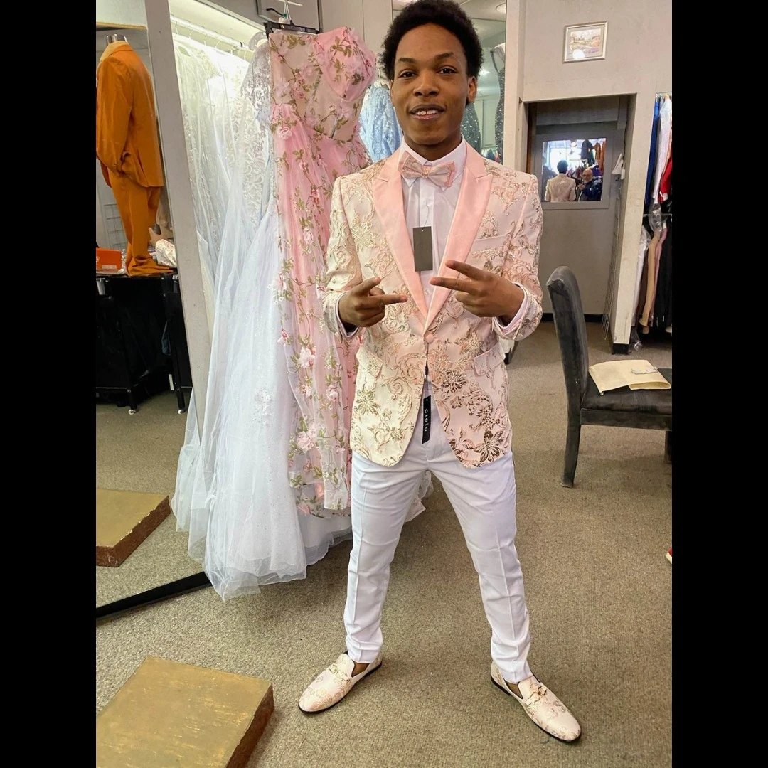 Client in pink and gold floral blazer with white pants and matching loafers