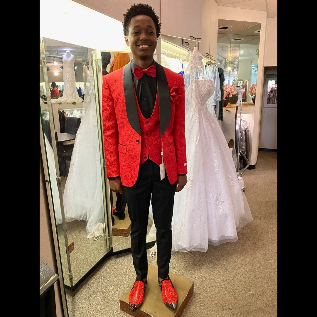 Client in red brocade tuxedo with matching vest and red crystal loafers