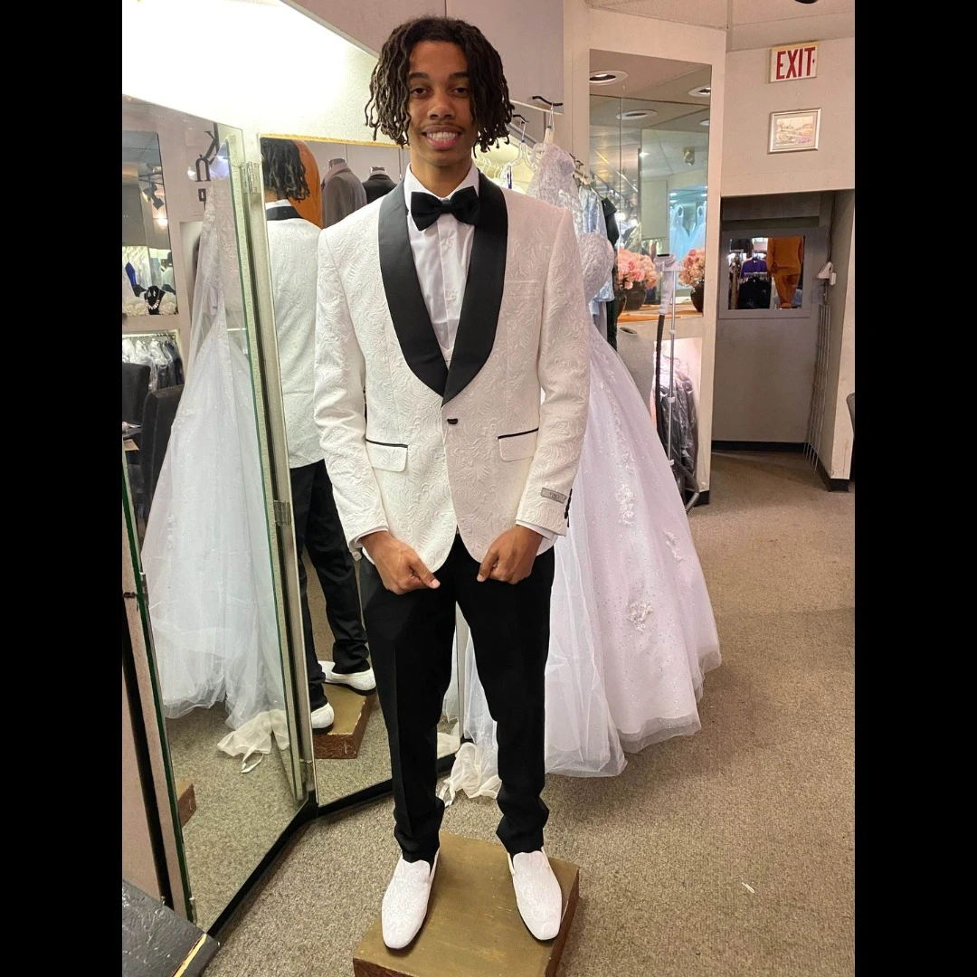 Client in white textured tuxedo jacket with black shawl lapel and bow tie