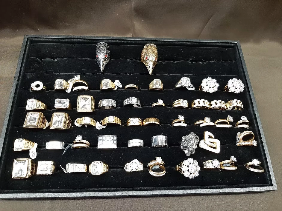 Collection of men's rings featuring gold, silver, and gemstone designs