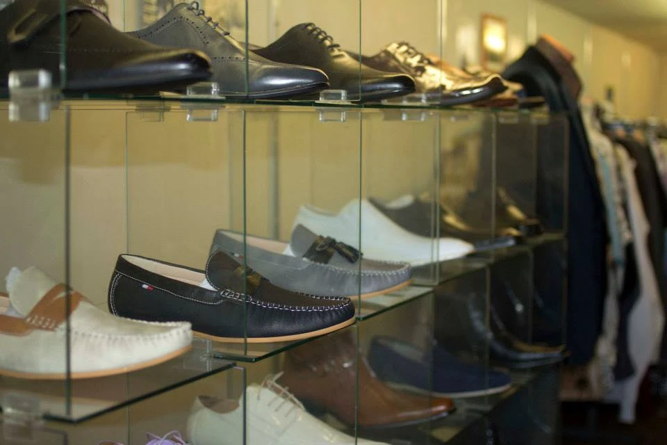Glass display of dress shoes, loafers, and oxfords