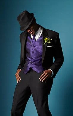 Black tuxedo with purple paisley vest, bow tie, and black fedora
