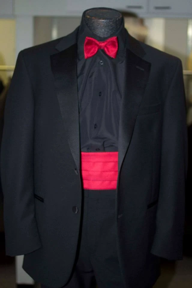Black tuxedo with red bow tie and cummerbund