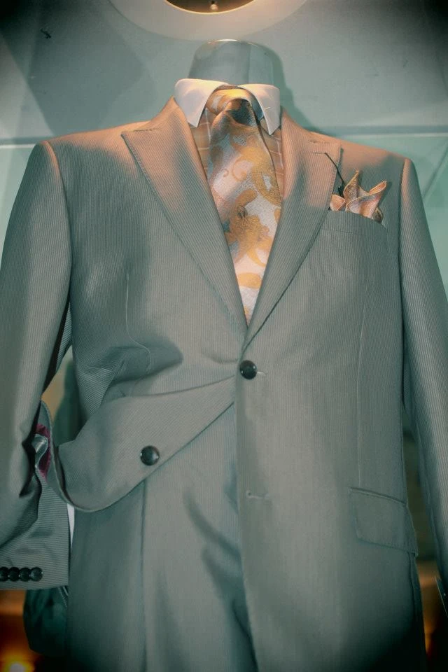 Light grey suit with gold baroque patterned tie and pocket square