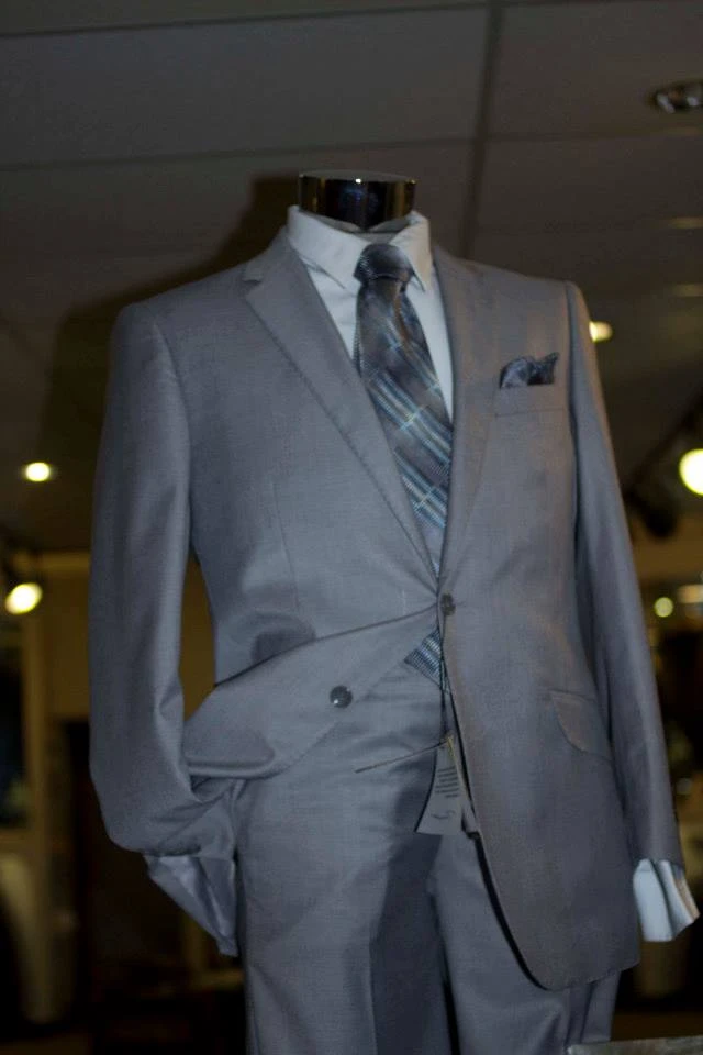 Light grey suit with blue striped tie and pocket square