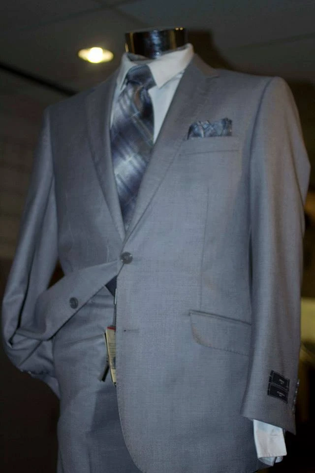 Light grey suit with plaid tie and matching pocket square