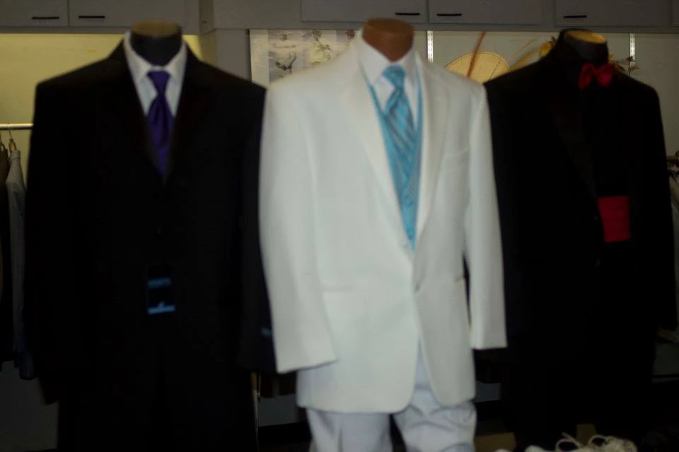 Store display of suits with white suit in center